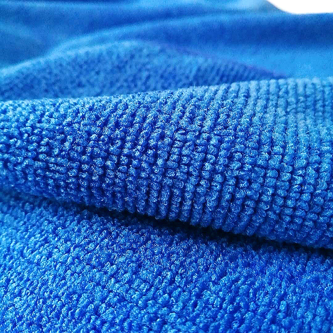 a close-up of a plain weave blue microfiber cloth
