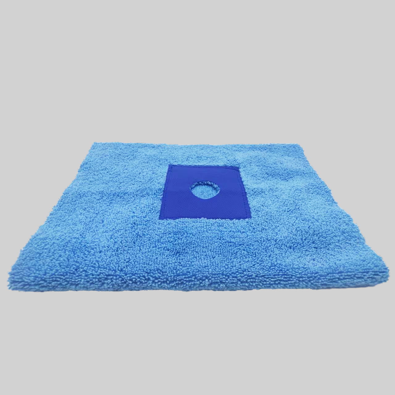 A comparison of a plain microfiber mop cloth and one with eyelets