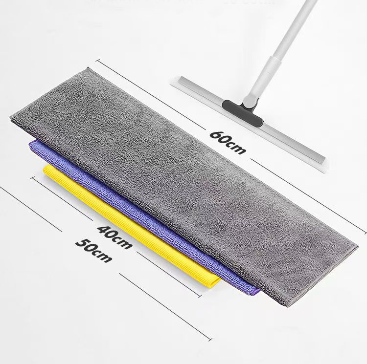 A person mopping a large living room floor with a wide mop