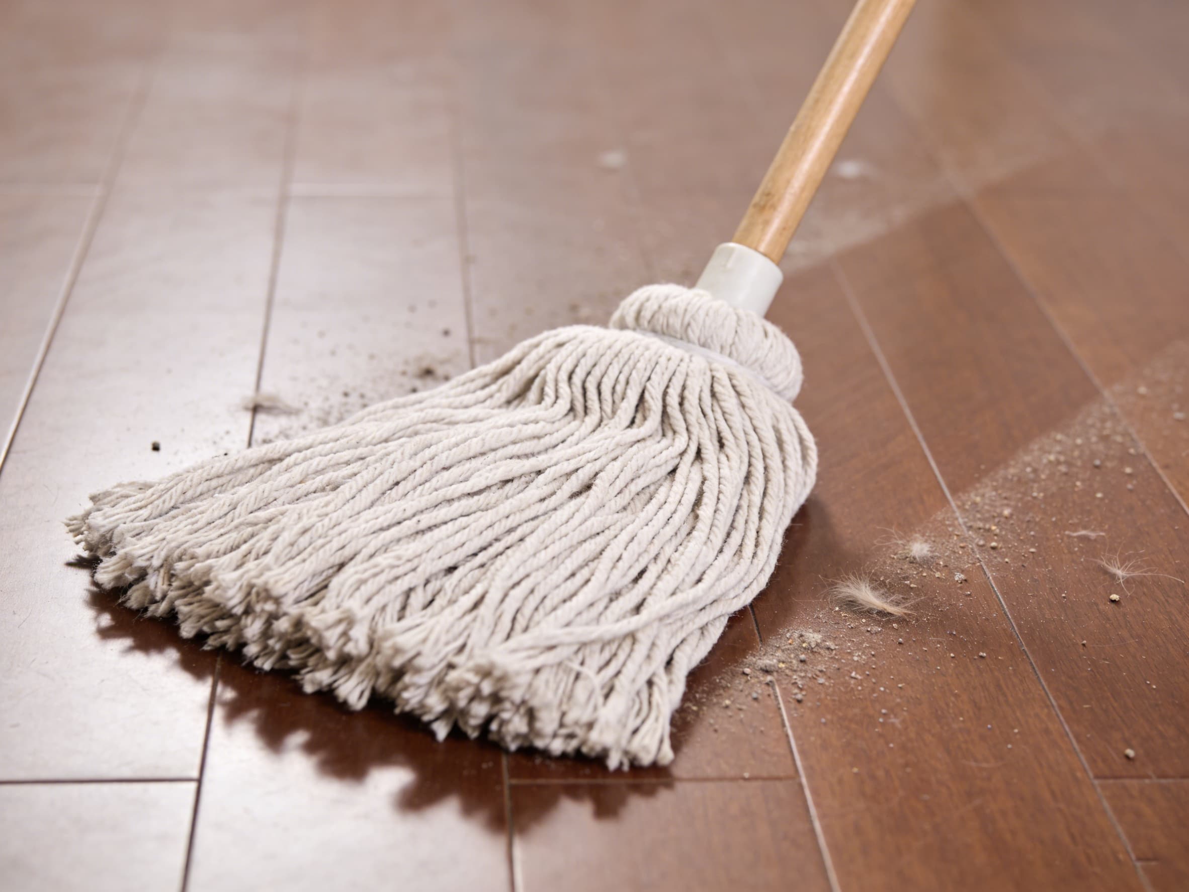 a microfiber mop being used dry to pick up dust and pet hair