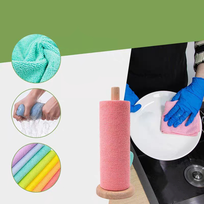 A hand wiping a kitchen counter spill with a blue microfiber sheet