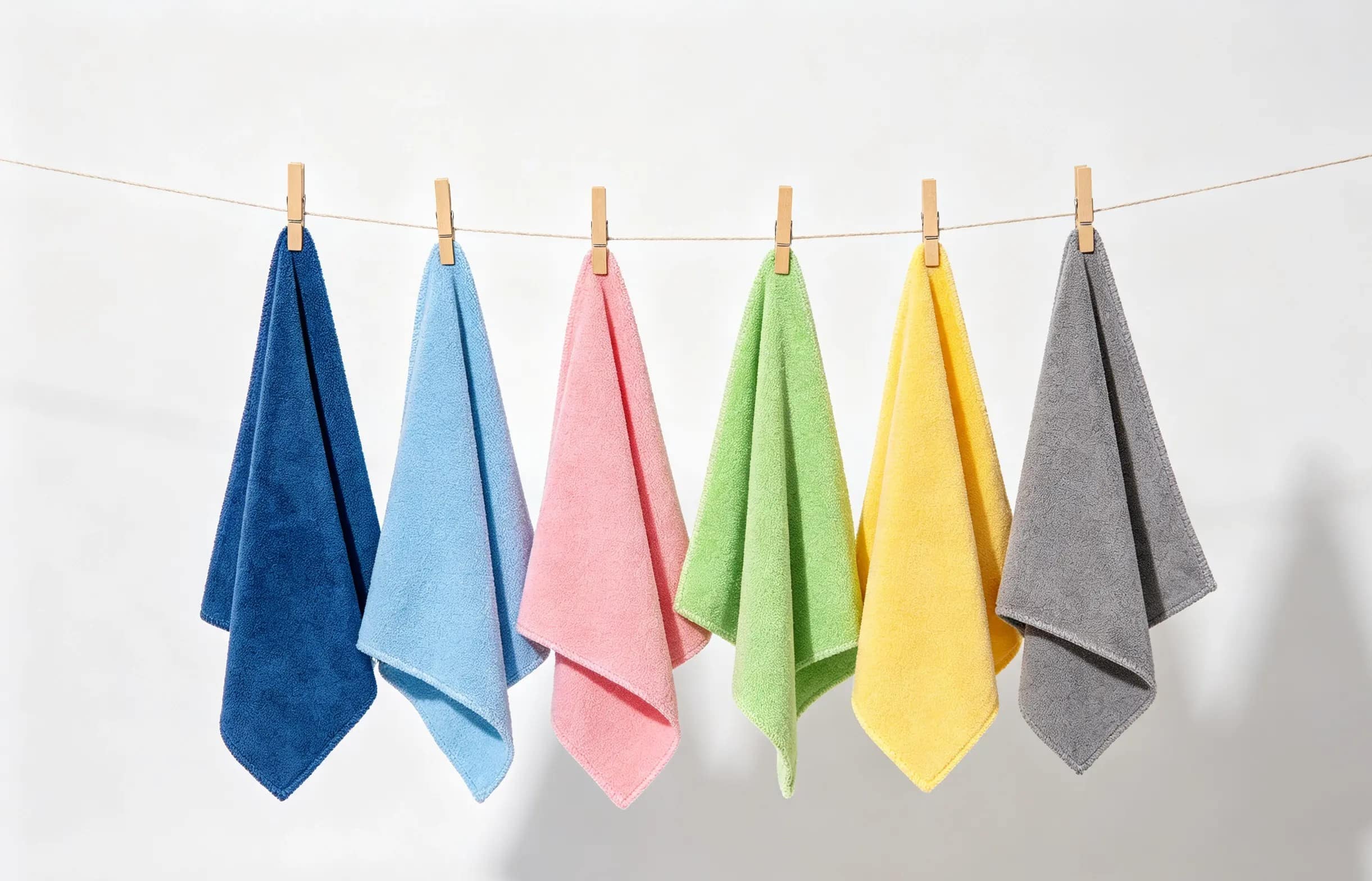 Color-coded microfiber cloths hanging on a line