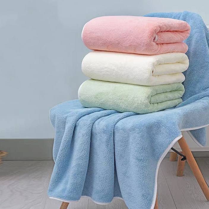 Stack of large microfiber bath towels in assorted pastel colors