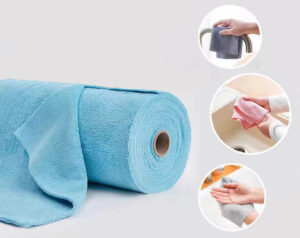 Hand tearing off a sheet from blue microfiber cloth roll for cleaning purposes