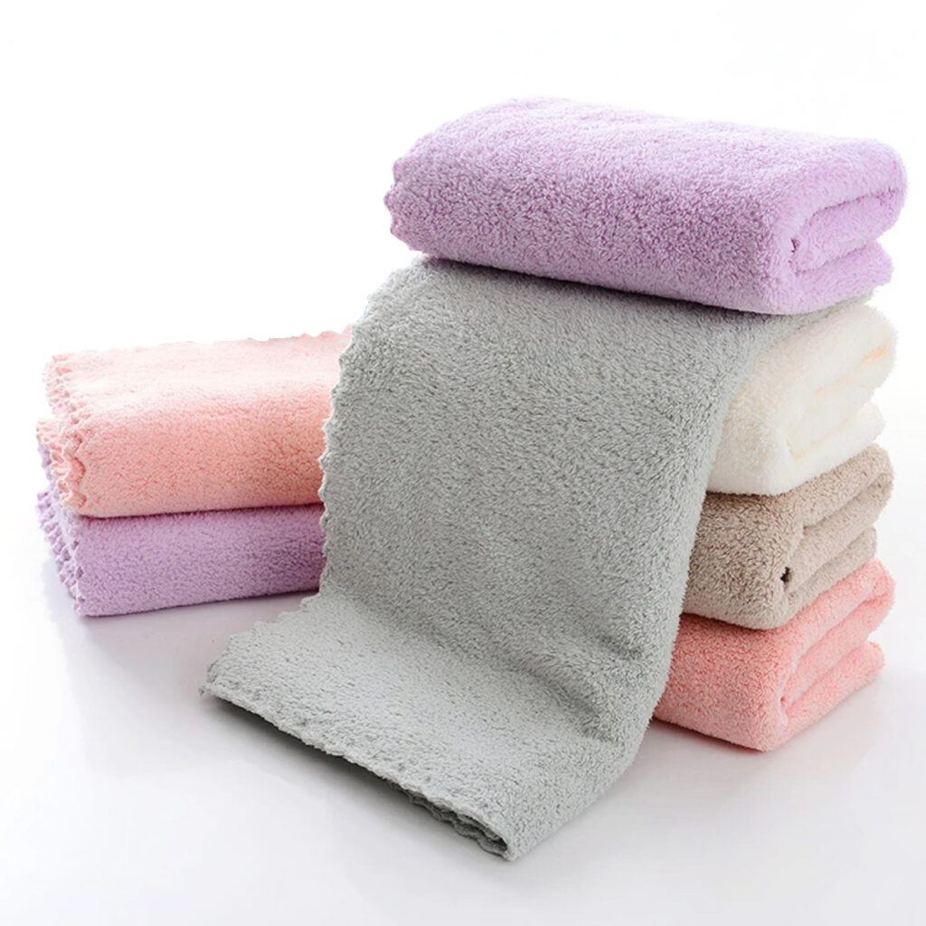 Stack of soft microfiber towels in purple, grey, pink, and beige tones