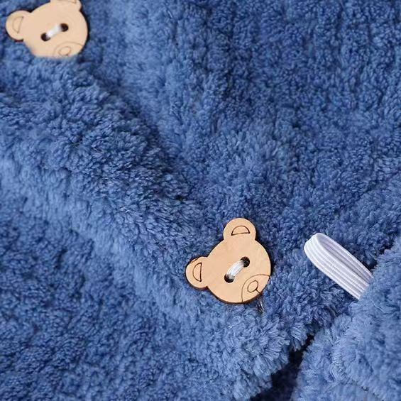 Thick navy blue coral fleece towel featuring a small teddy bear clip decoration