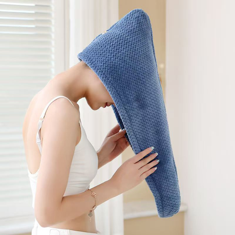 Woman with wet hair using blue microfiber coral fleece towel after bath