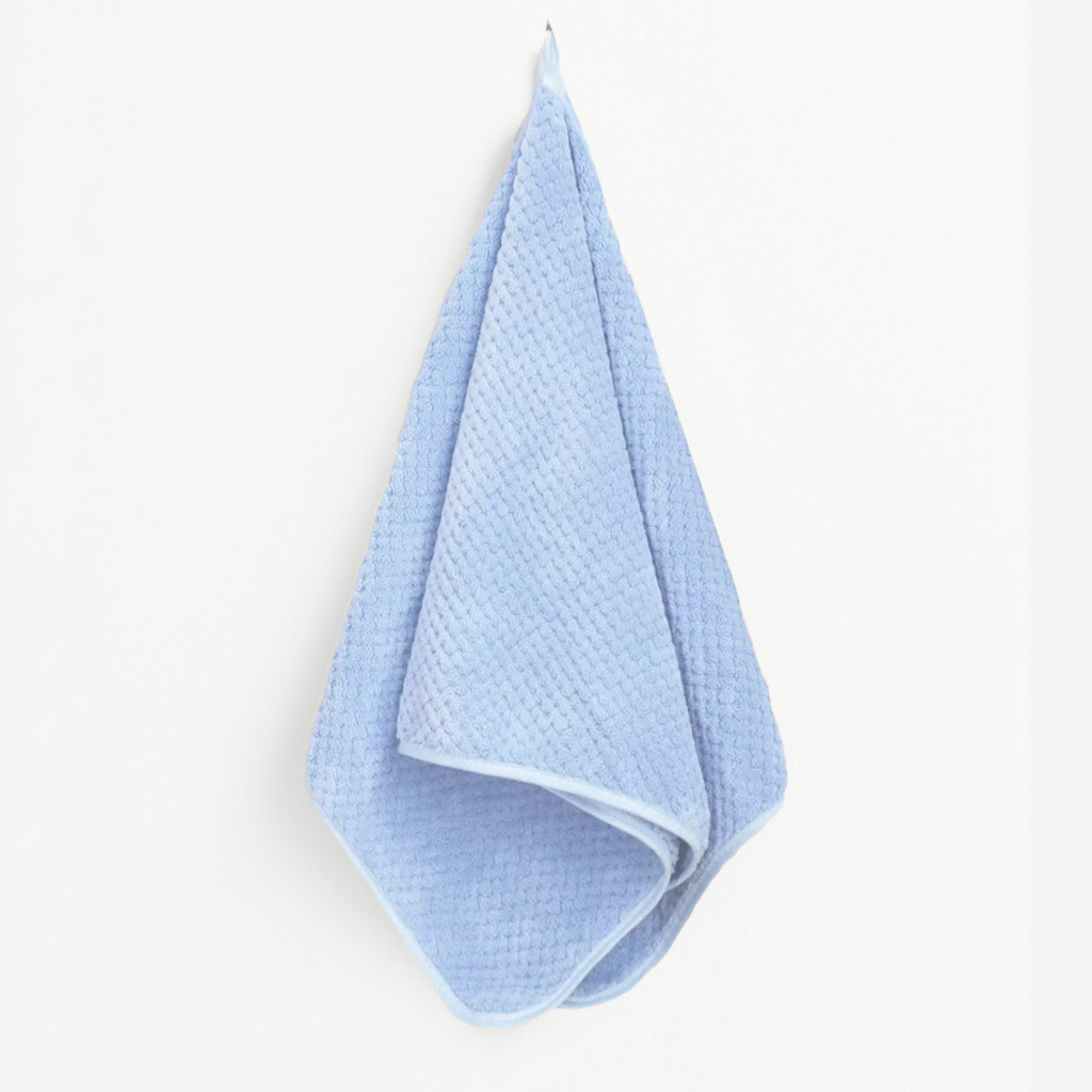 Single blue microfiber towel hanging naturally with soft folds