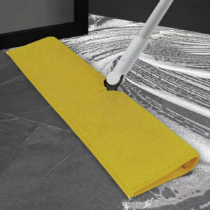 Durable yellow mop cloth in use for commercial cleaning on ceramic tiles